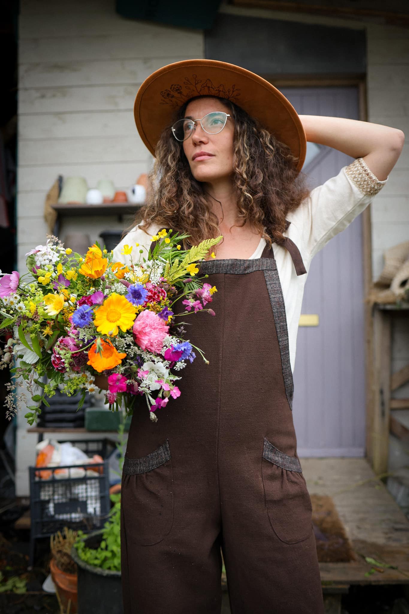 Discover our Meadow Brown Dungarees, an earthy brown jumpsuit trimmed with oak tweed, designed for folklore-inspired style, comfort, and everyday wear