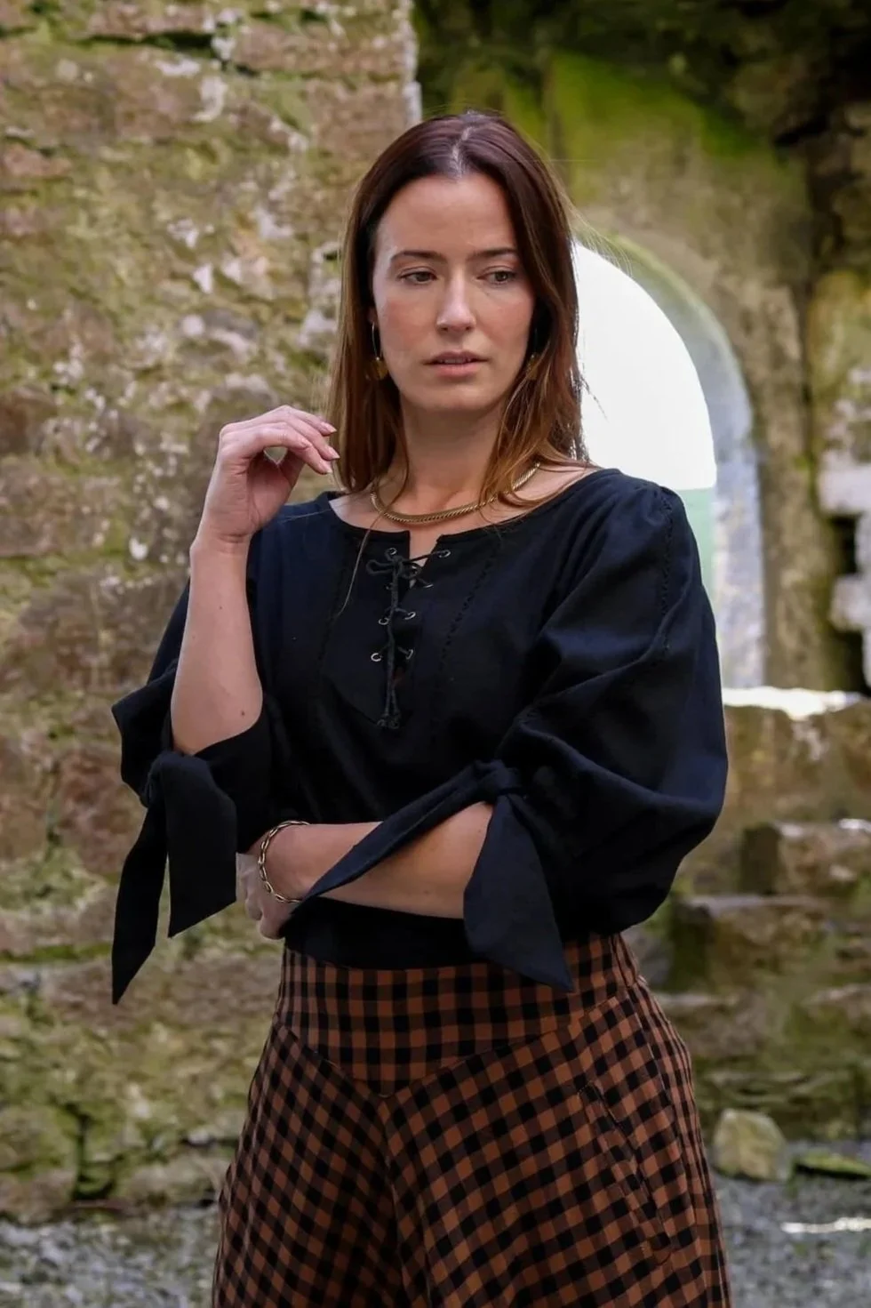 Black Grace O'Malley pirate queen shirt with lace-up tunic and knot-tie sleeves.
