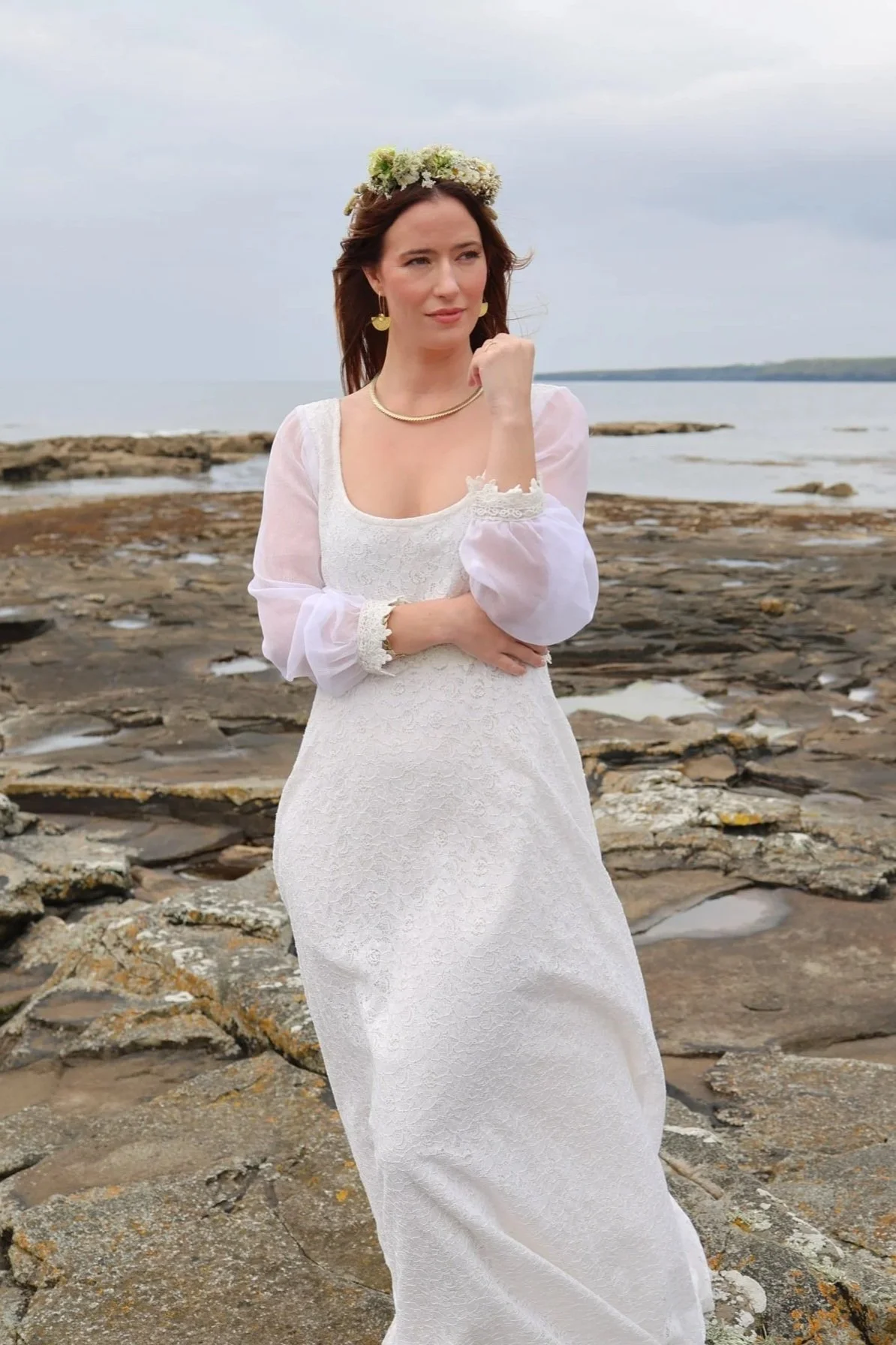 The Annagh Wedding Dress is an elegant cotton lace bridal gown with flowing bishop chiffon sleeves, a romantic low back, and ethical slow fashion values