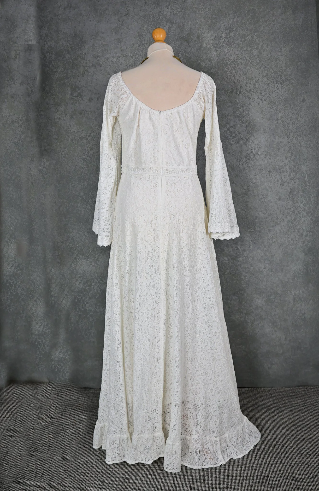 Bébhinn Boho Wedding Dress with off-the-shoulder neckline, bell sleeves, and flowing A-line cotton lace skirt. Custom-made for free-spirited brides.