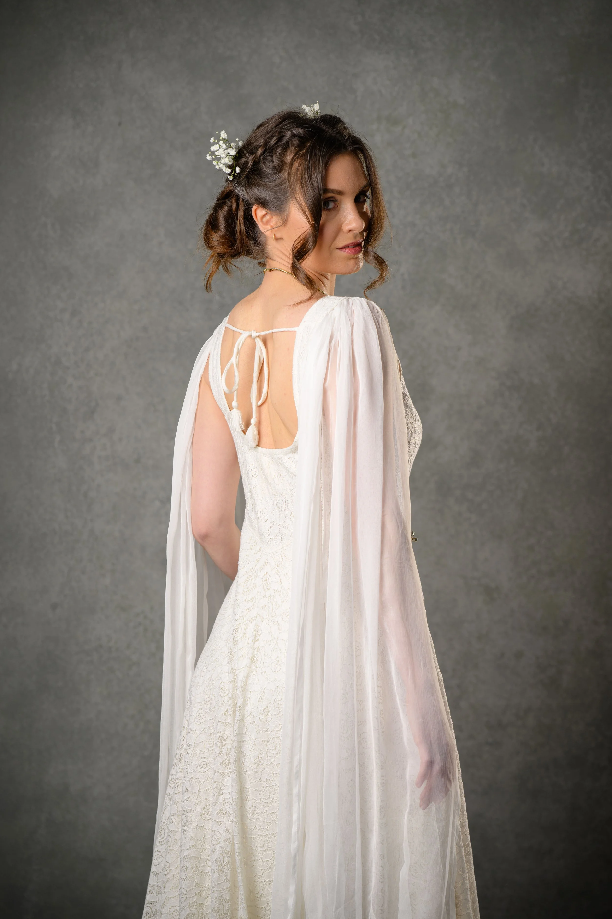 Caped wedding dress with low back in lace.jpg