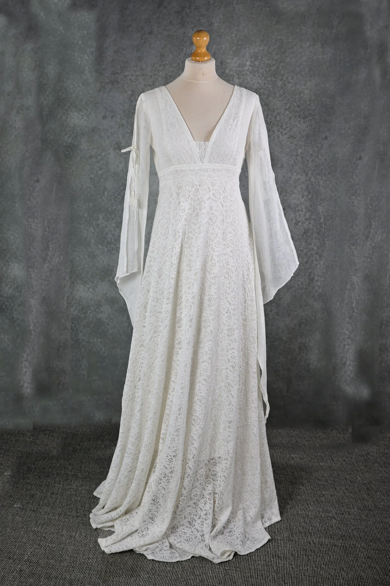 Ava Wedding Dress, An Irish-designed lace gown with flowing linen net sleeves and tie details, perfect for folklore-inspired and sustainable bridal style.