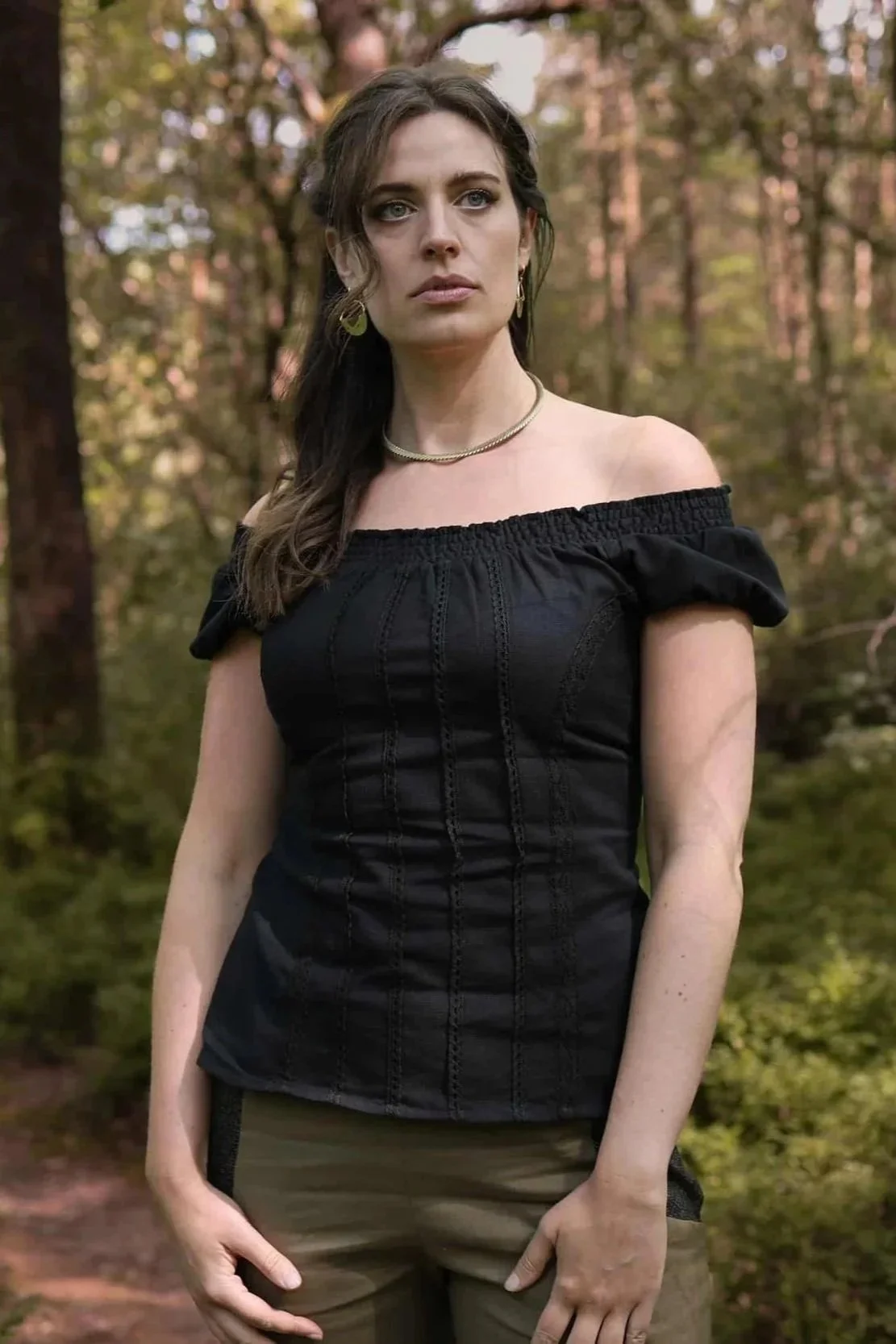 A romantic black corset top inspired by folklore style, featuring puffed sleeves, cotton lace detailing, and a flattering corset tie back.