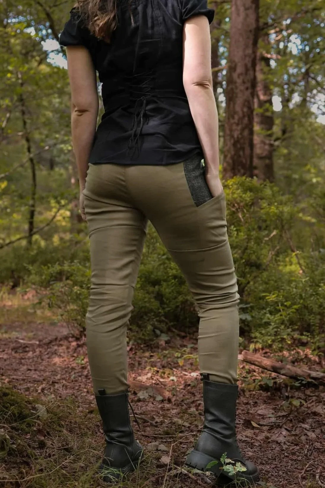 A model wears the Tara Linen Leggings, sustainable clothing linen blend trousers with tweed wool plaid pockets designed by Celtic Fusion.