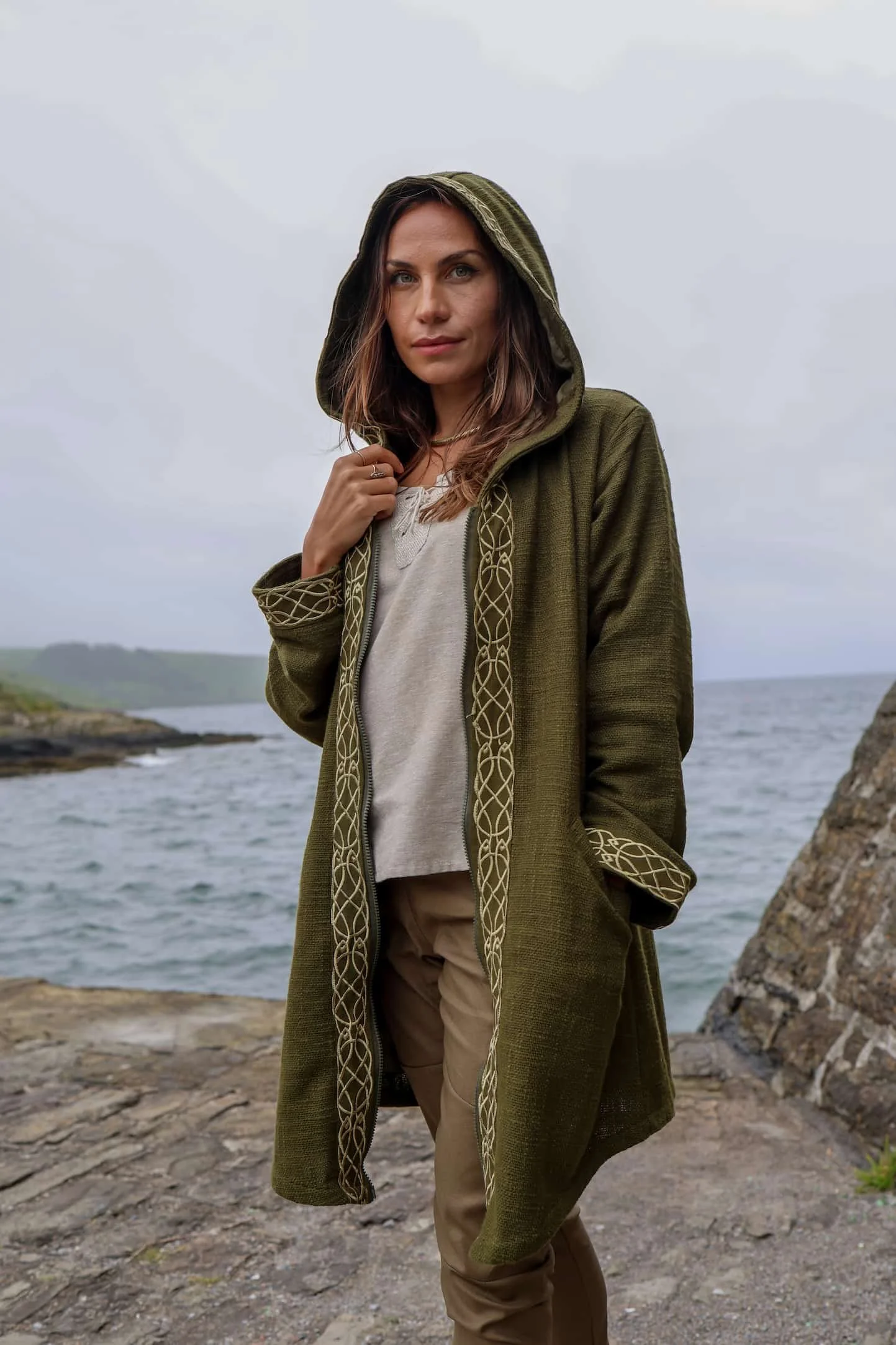 Discover a stylish Celtic jacket featuring Celtic knotwork embroidery, crafted from 100% heavy cotton slub with an Irish design, deep hood, pockets, and zipper closure.