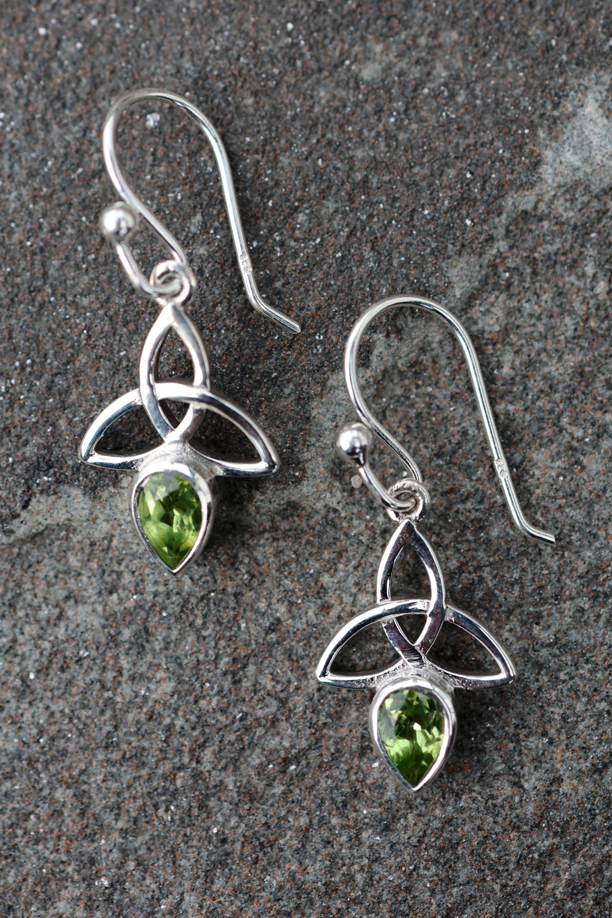 These Trinity Knot Earrings in sterling silver feature vibrant peridot gemstones and Celtic symbolism, handcrafted Celtic jewellery with meaning.