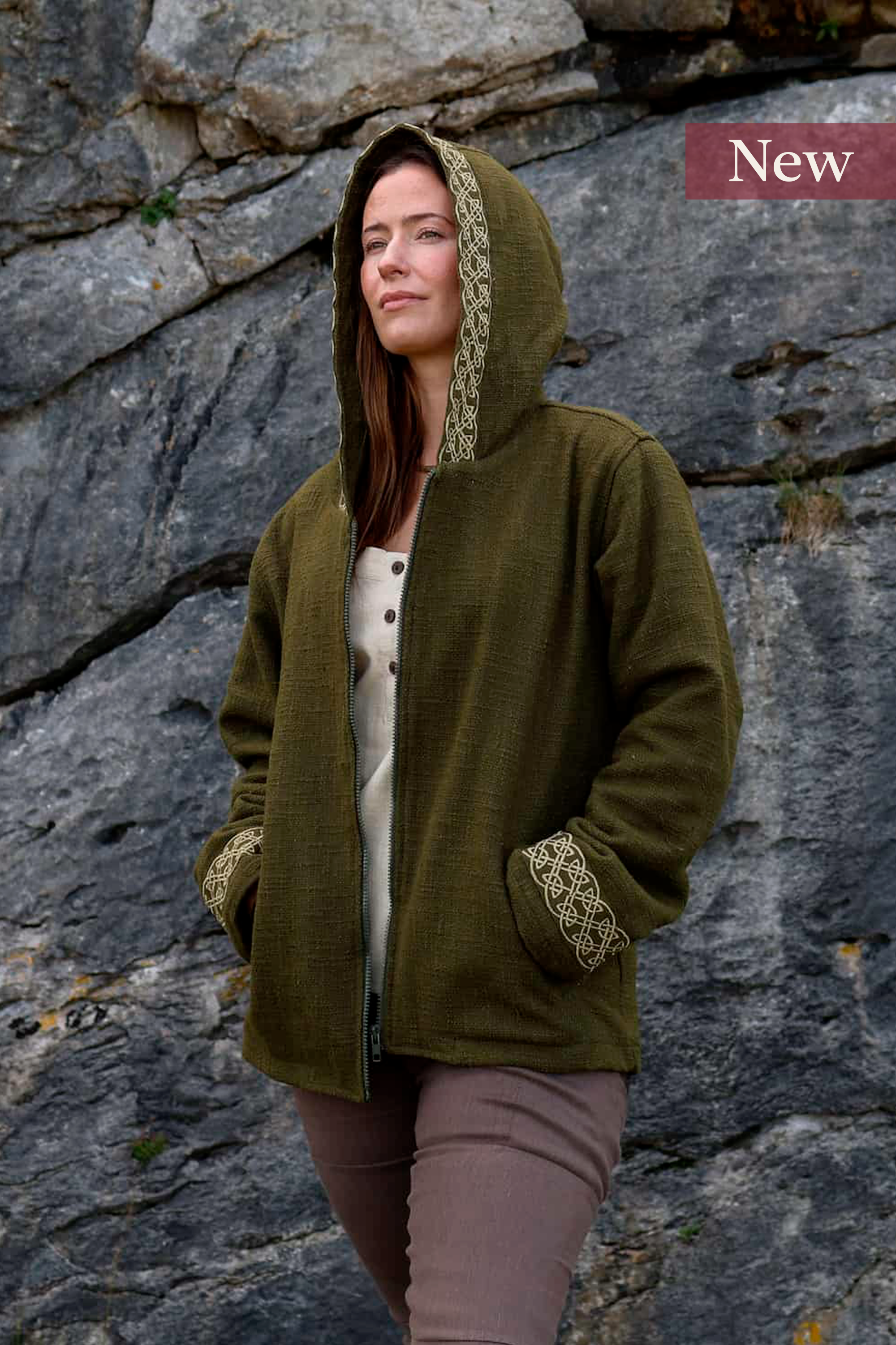 A woman wears the moss green Hooded Jacket with Fleece Lining and Embroidered Celtic Knotwork