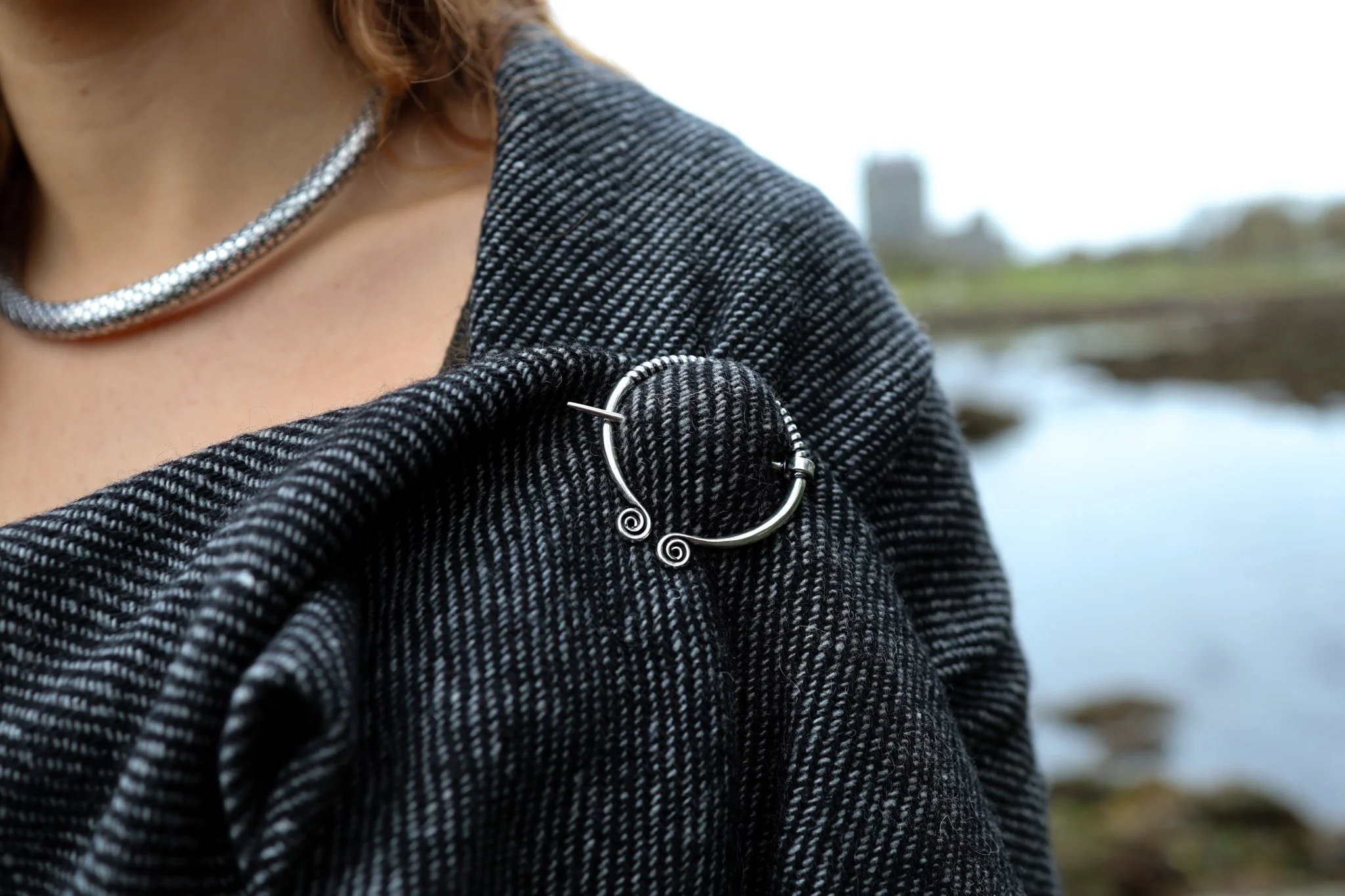 Handcrafted silver-plated brass Celtic Spiral Shawl Brooch. Inspired by ancient penannular designs, this elegant brooch is perfect for fastening handwoven shawls and cloaks