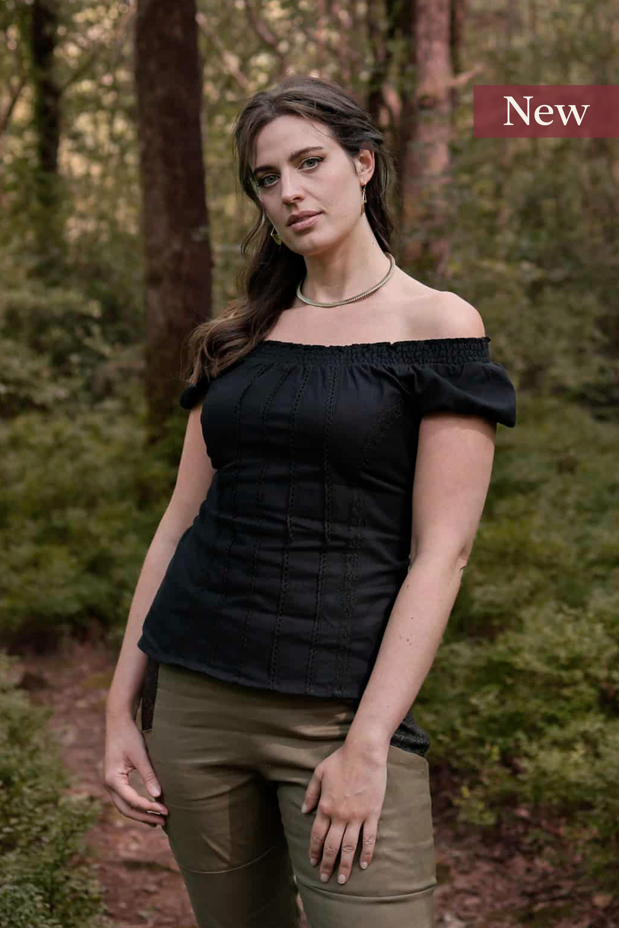 A romantic black corset top inspired by folklore style, featuring puffed sleeves, cotton lace detailing, and a flattering corset tie back.