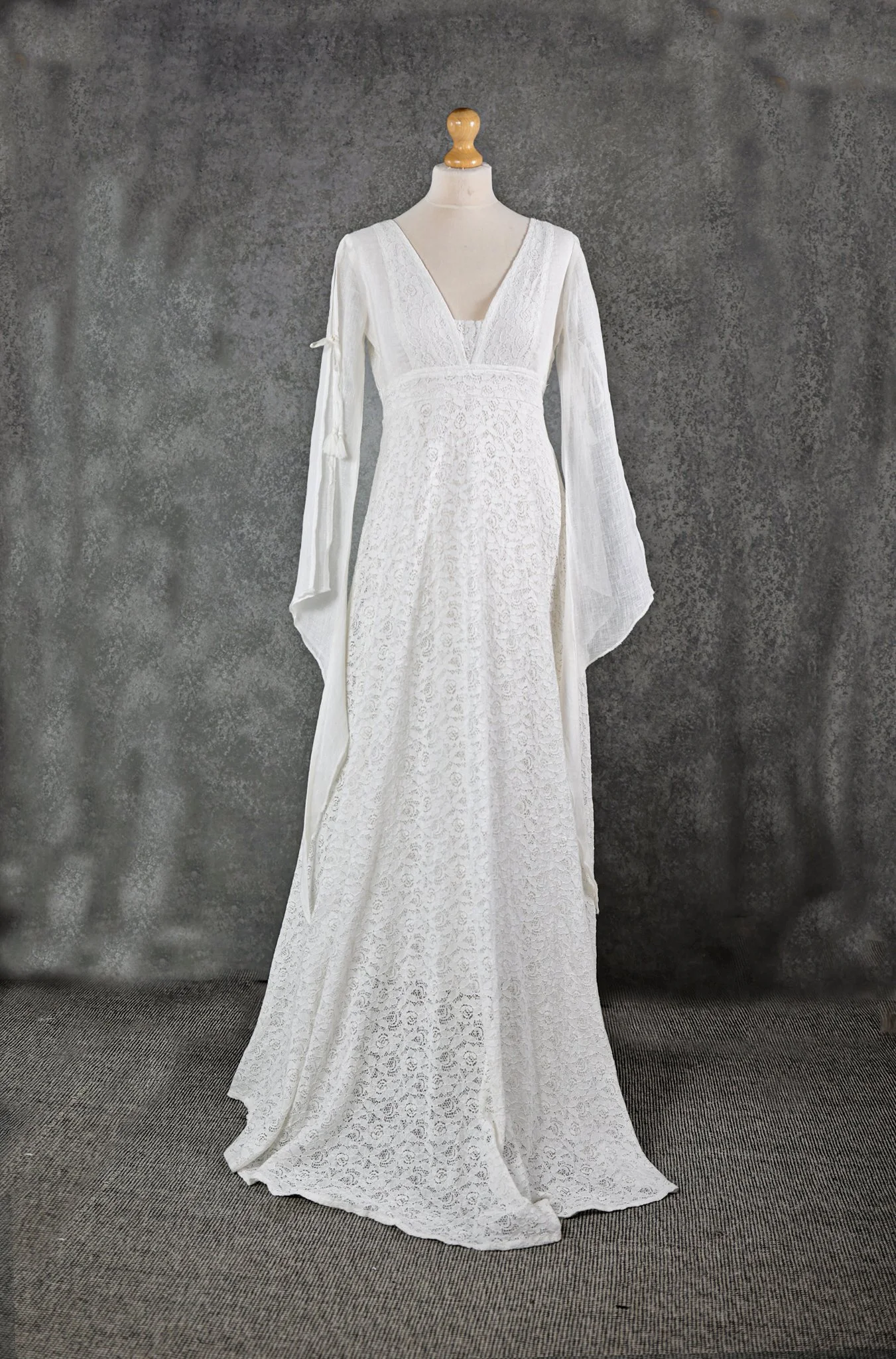 Ava Wedding Dress, An Irish-designed lace gown with flowing linen net sleeves and tie details, perfect for folklore-inspired and sustainable bridal style.