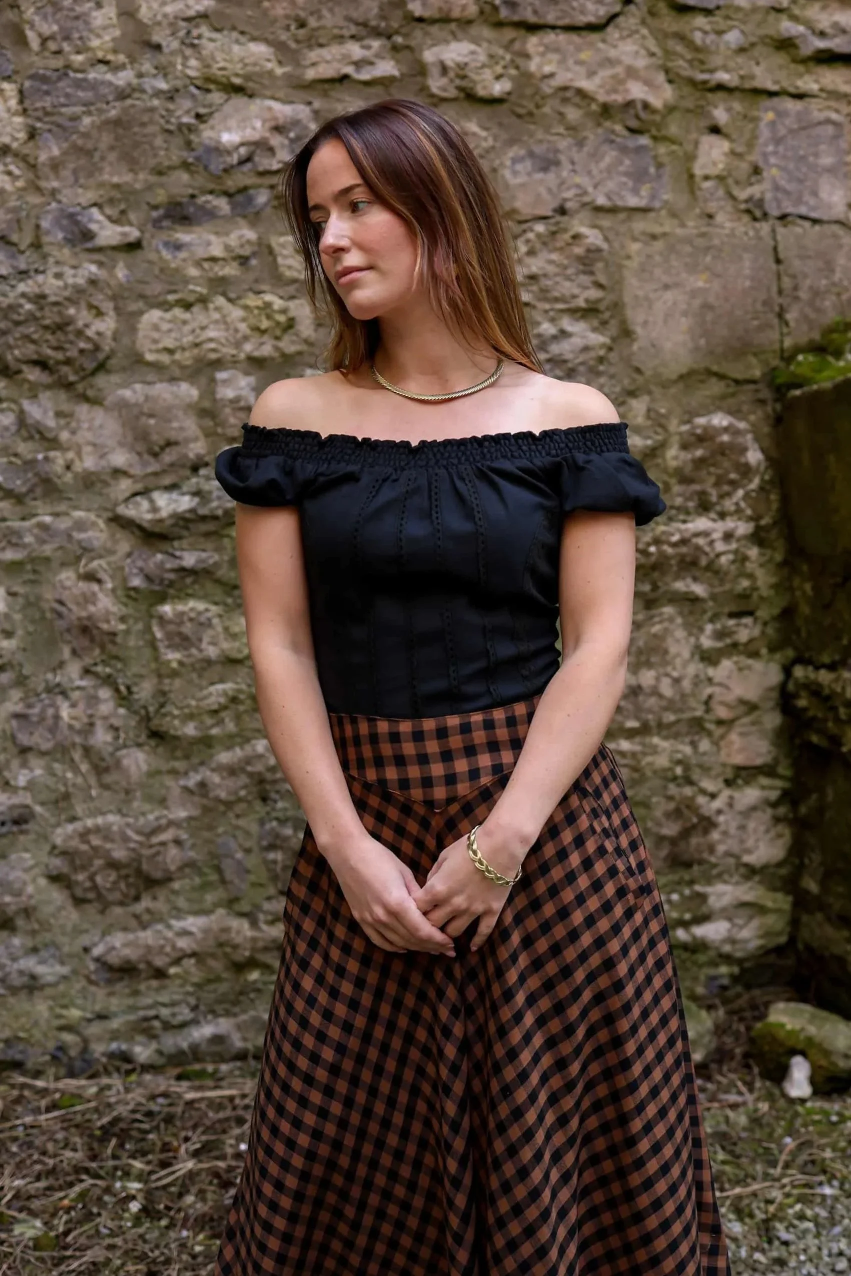 A romantic black corset top inspired by folklore style, featuring puffed sleeves, cotton lace detailing, and a flattering corset tie back.