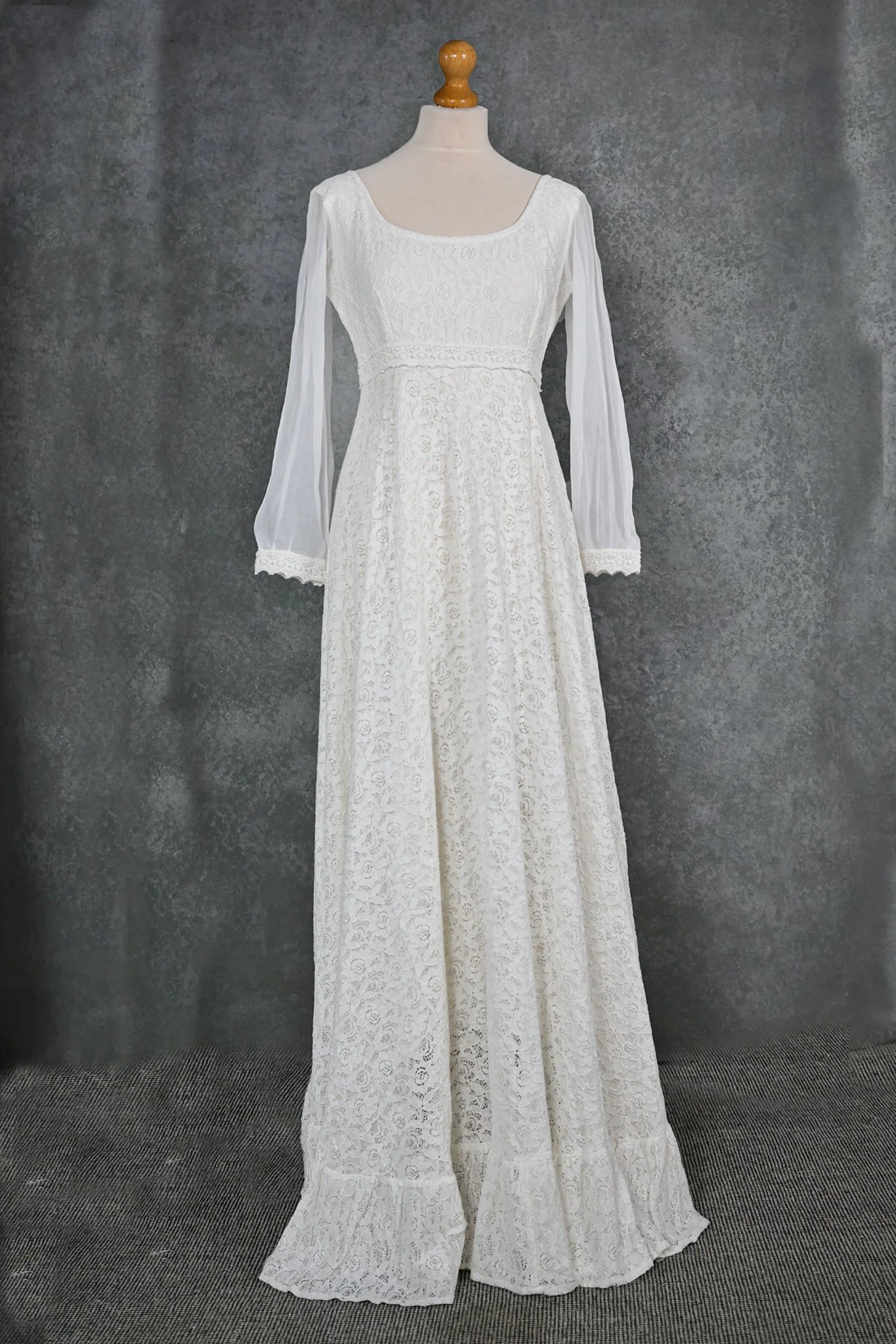 The Annagh Wedding Dress is an elegant cotton lace bridal gown with flowing bishop chiffon sleeves, a romantic low back, and ethical slow fashion values