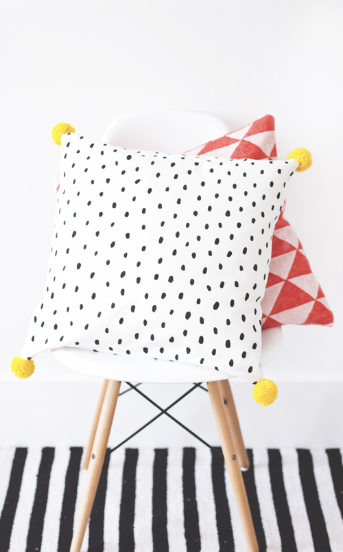 And these painted pillows from The Lovely Drawer are similar, but I love the pom poms and the polka dots. I seem to be drawn to black and white patterns lately...so I'm thinking my "funky" pillows for my sofa styling will probably have some kind of black and white theme. :)