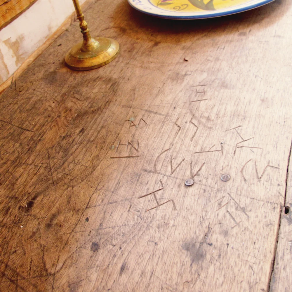   Cowboys carved their brands into this table. This cabin was about 150 years old; this cowboy graffiti has been around for a while!  