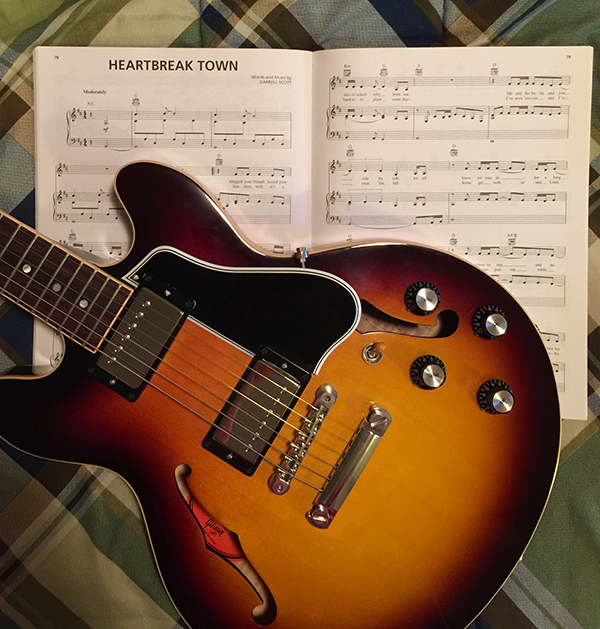 Elissa enjoys playing 'Heartbreak Town' on her guitar. 