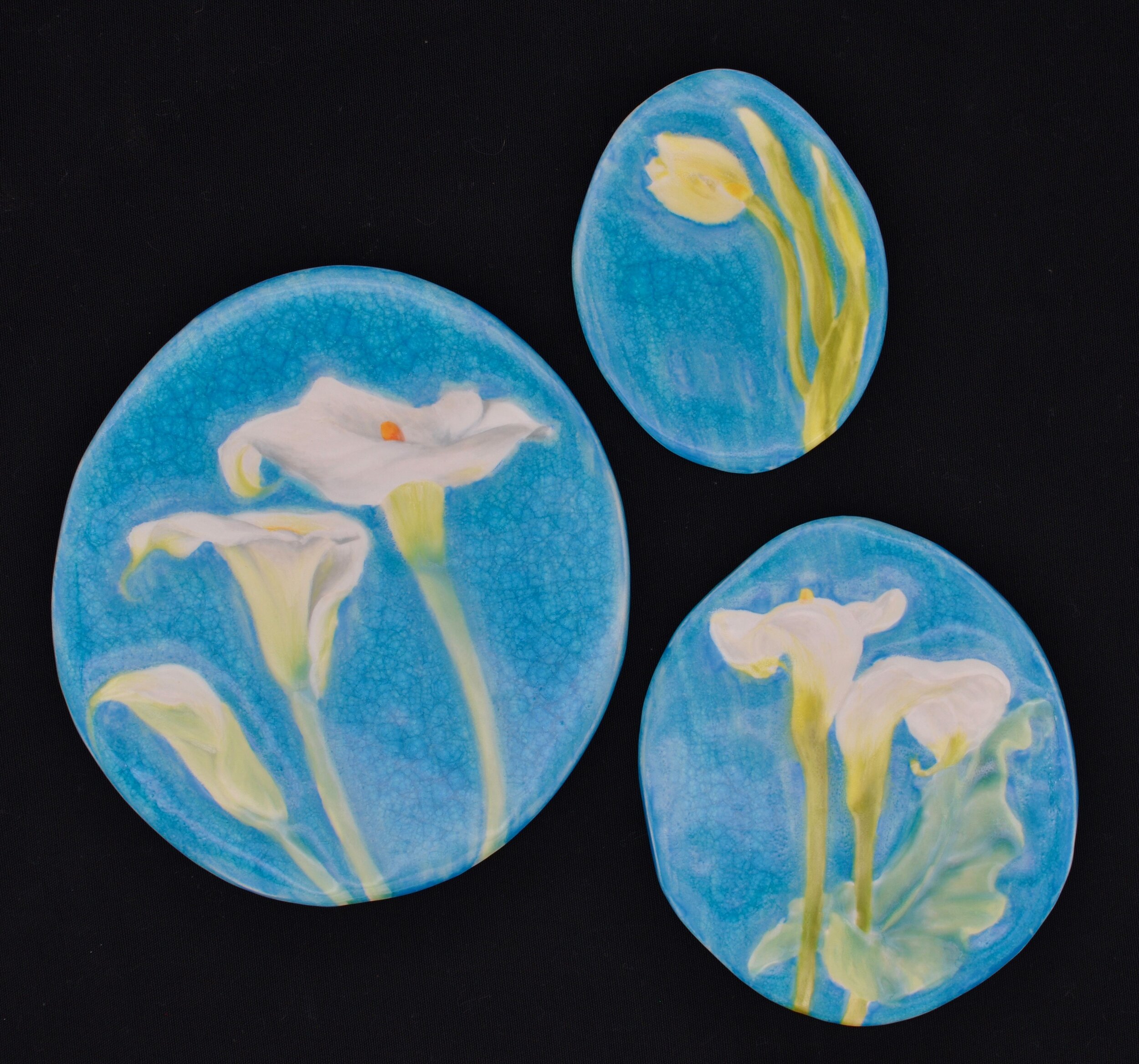  Clockwise from left:  1) Three Callas - 8” tall oval tile ($60)  2) Tulip - 5” tall oval tile ($25)  3) Two Callas - 6.5” tall oval tile ($40) 