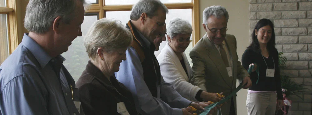 Grand Opening April 2006: From left ; former Mayor of Mulmur Township Gord Gallaugher, Past President of Rotary Club of Toronto Sylvia Milne, Pine River Founding Board Chair Ron Crane. The Way Back Campaign Chair Don Wright, Pine River Founder Karen Minden, Pine River Founding Board Member Michael Morgan, Pine River Co-Founder Samantha Yamada (far left, holding the other end of the ribbon, Pine River Co-Founder Elyse Schipper)