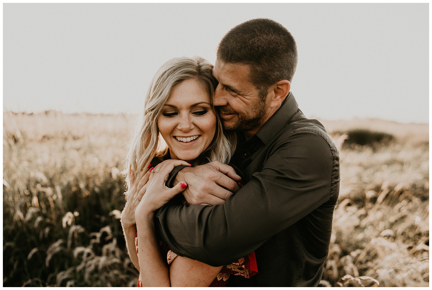 cute couple posing in field