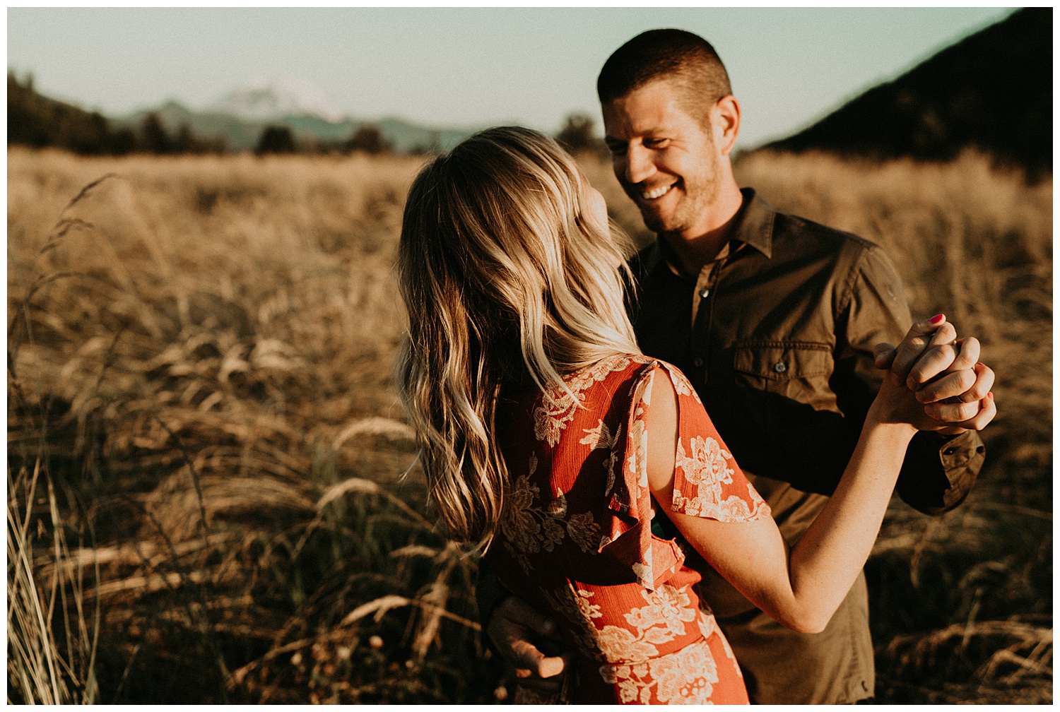 cute couple dancing in field