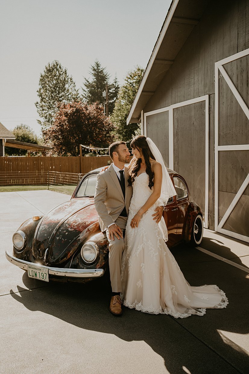  first look kiss pose with restored vw beetle 