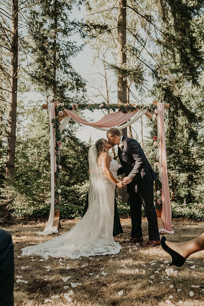  first kiss at bride and groom’s backyard wedding 