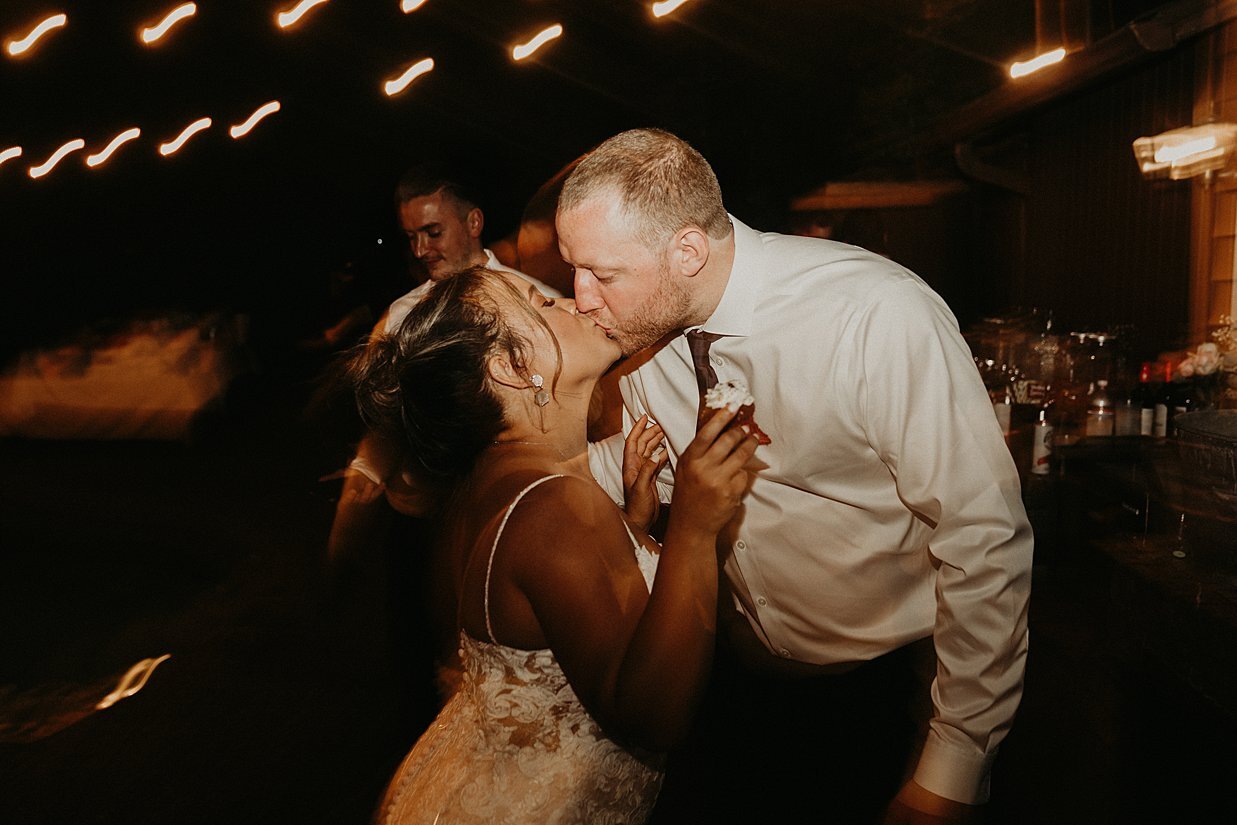  bride and groom kiss while dancing at reception in their own backyard 