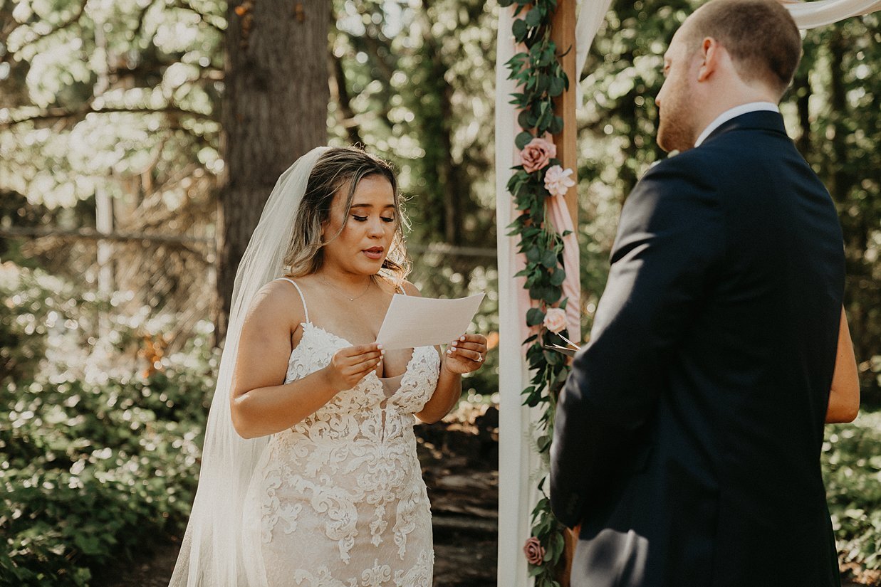  bride saying vows at DIY backyard wedding 