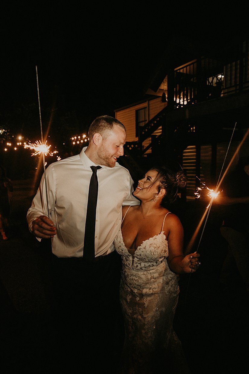  bride and groom with sparklers at their backyard wedding 