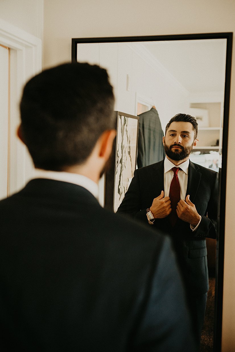  groom looking in mirror at alderbrook resort in union wa 