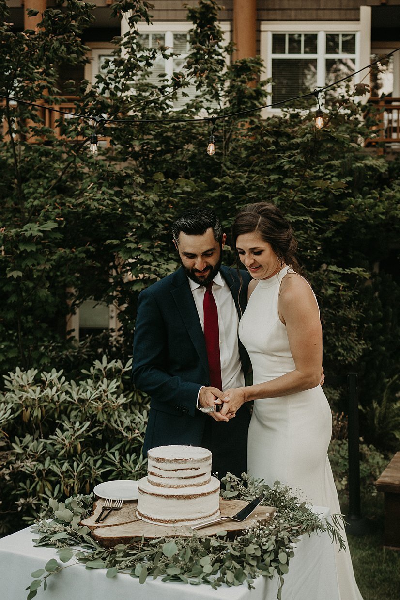  bride and groom cake cutting on outdoor patio 
