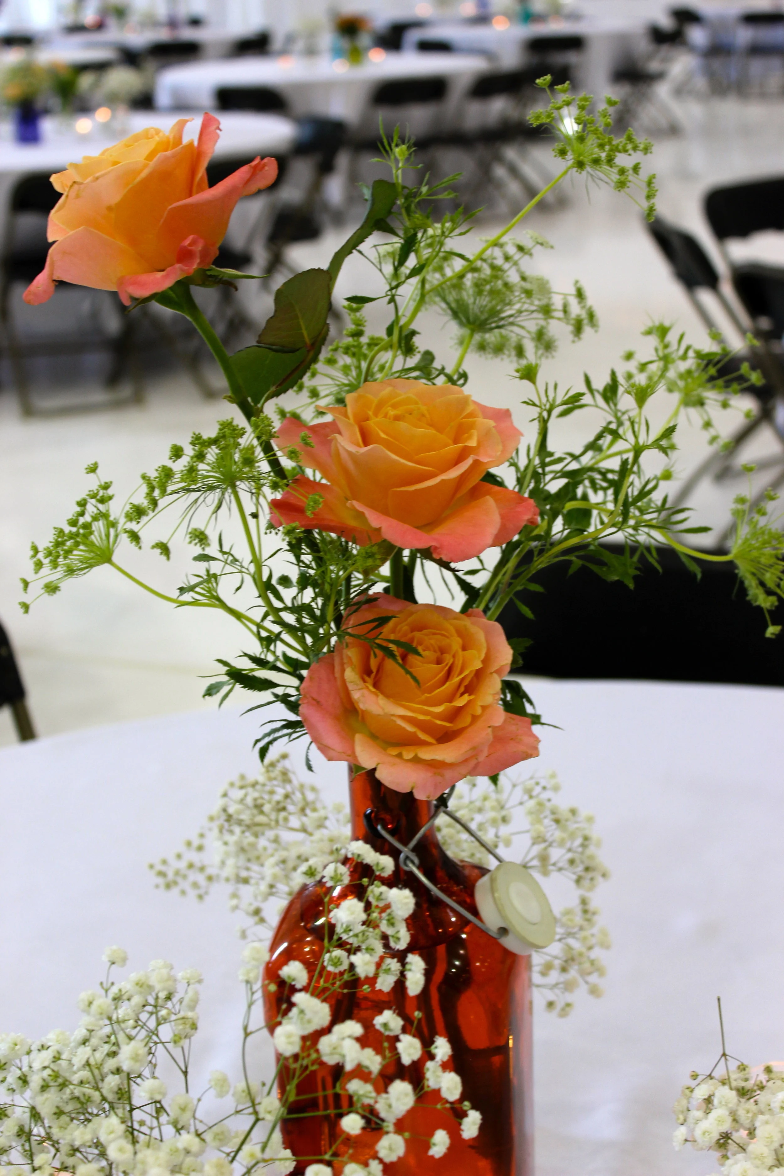 Tables with mixed vases and simple flowers