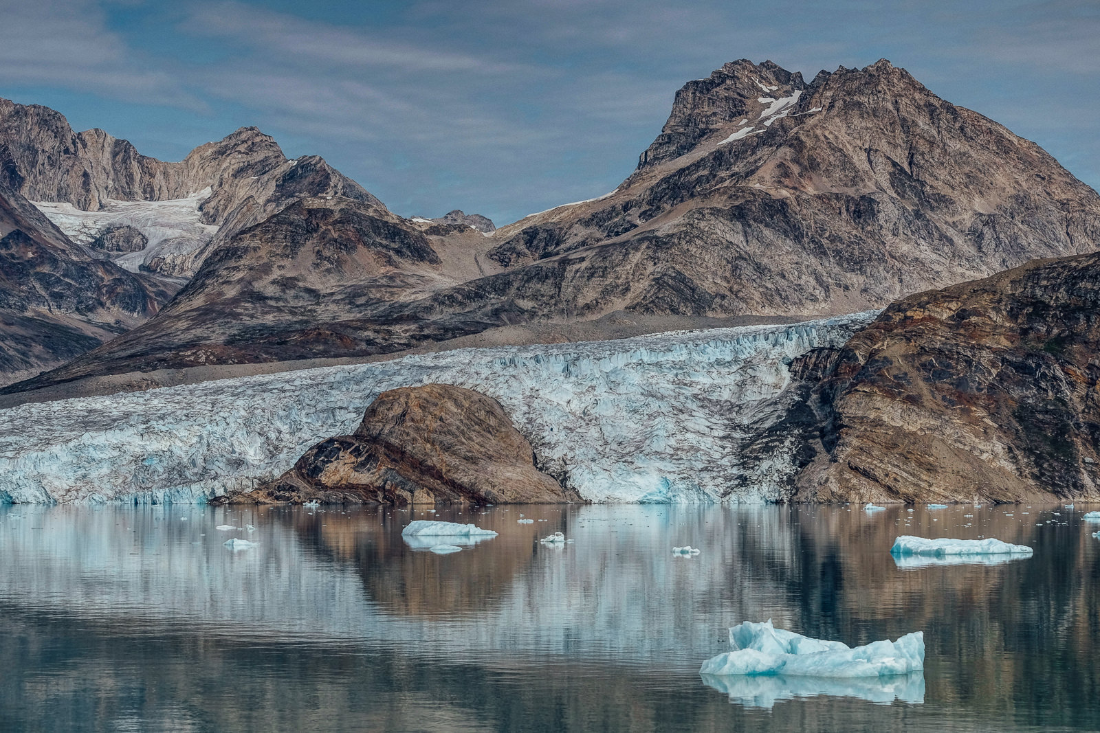 the turtle-like granite rock comes out of the glacier like a giant prehistoric animal awaken after an ice-age. Image taken at Karale fjord, East Greenland.