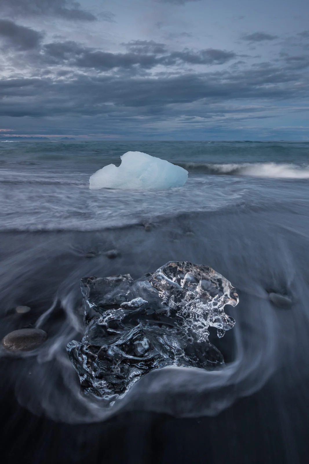 Blue hour at the Jökulsárlón diamond beach. Probably the trickiest shot I took ... camera was low on tripod, too close to waves for comfort, so every now and then I had to grab tripod and lift it up or run away from waves. Strong winds and low light, moving ice, moving sand, moving waves... and cold water in my boots, overall a full Icelandic experience :) but it was absolutely worth it! (XF 10-24mm f4 at 14mm 13/10s f10 ISO200)