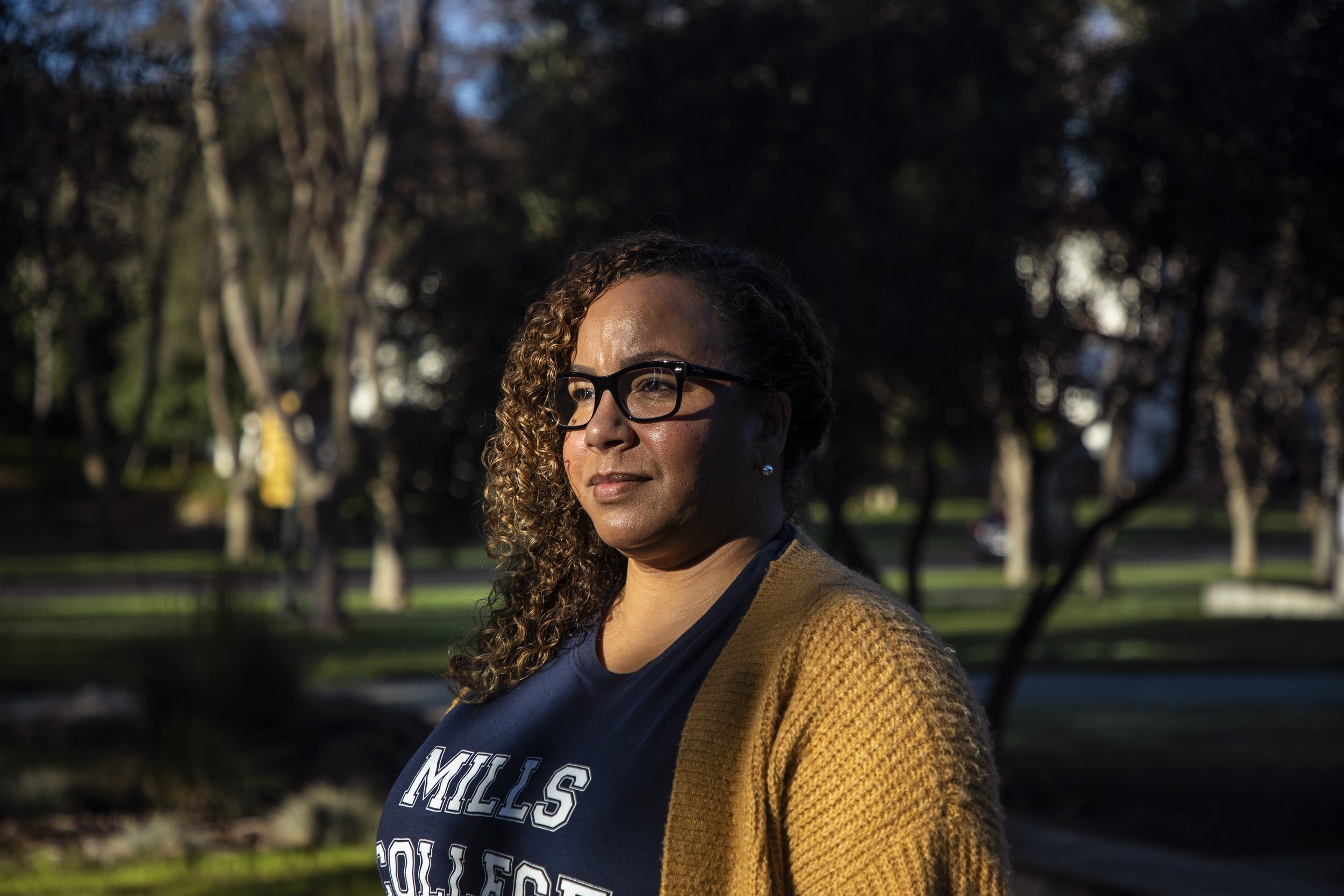  Shay Franco-Clausen stands out front of the Lokey School of Business and Public Policy at Mills College, where she is enrolled as a masters student on Jan.14, 2022. Photo by Martin do Nascimento/CalMatters 