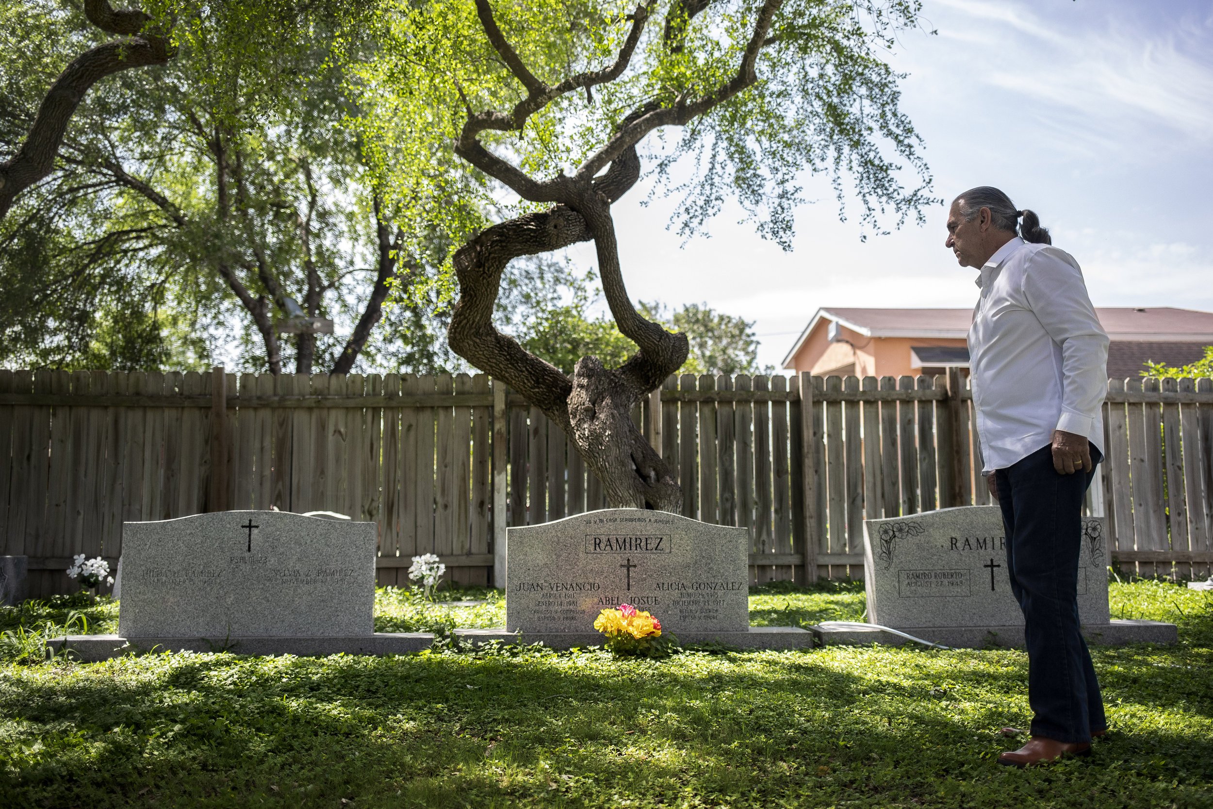  Ramiro Ramirez looks at the graves of his parents and the headstone for hiomself and his wife at the Jackson Chapel Cemetary in San Juan, TX. 