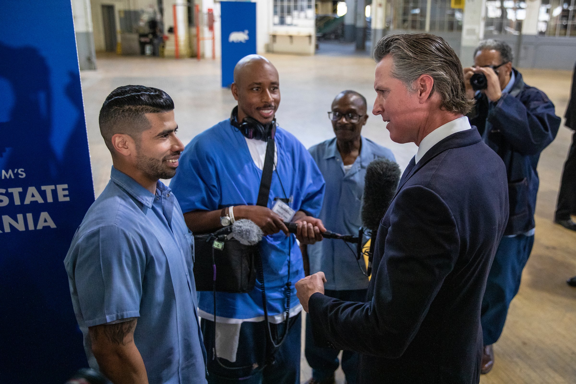  Ryan Pagan (left), an inmate serving a life sentence who is involved with the Forward This Productions media program at San Quentin State Prison, speaks with Gov. Gavin Newsom at San Quentin State Prison on March 17, 2023. Photo by Martin do Nascime