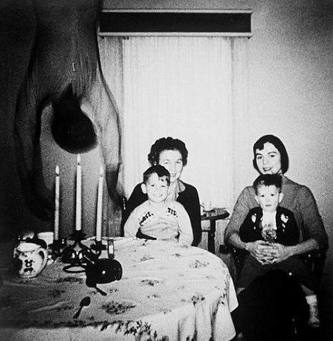 a terrifying photograph taken at god knows when from god knows where. Spoiler alert, the family died. Just kidding, well the family is likely dead now but not because of an upside down flailing shadowmonster...i think.