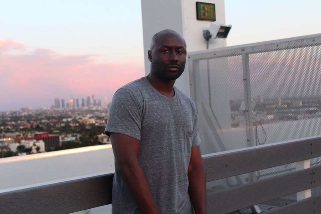 Malcolm Gray on a rooftop overlooking the Los Angeles skyline. Photo by @dre.a 