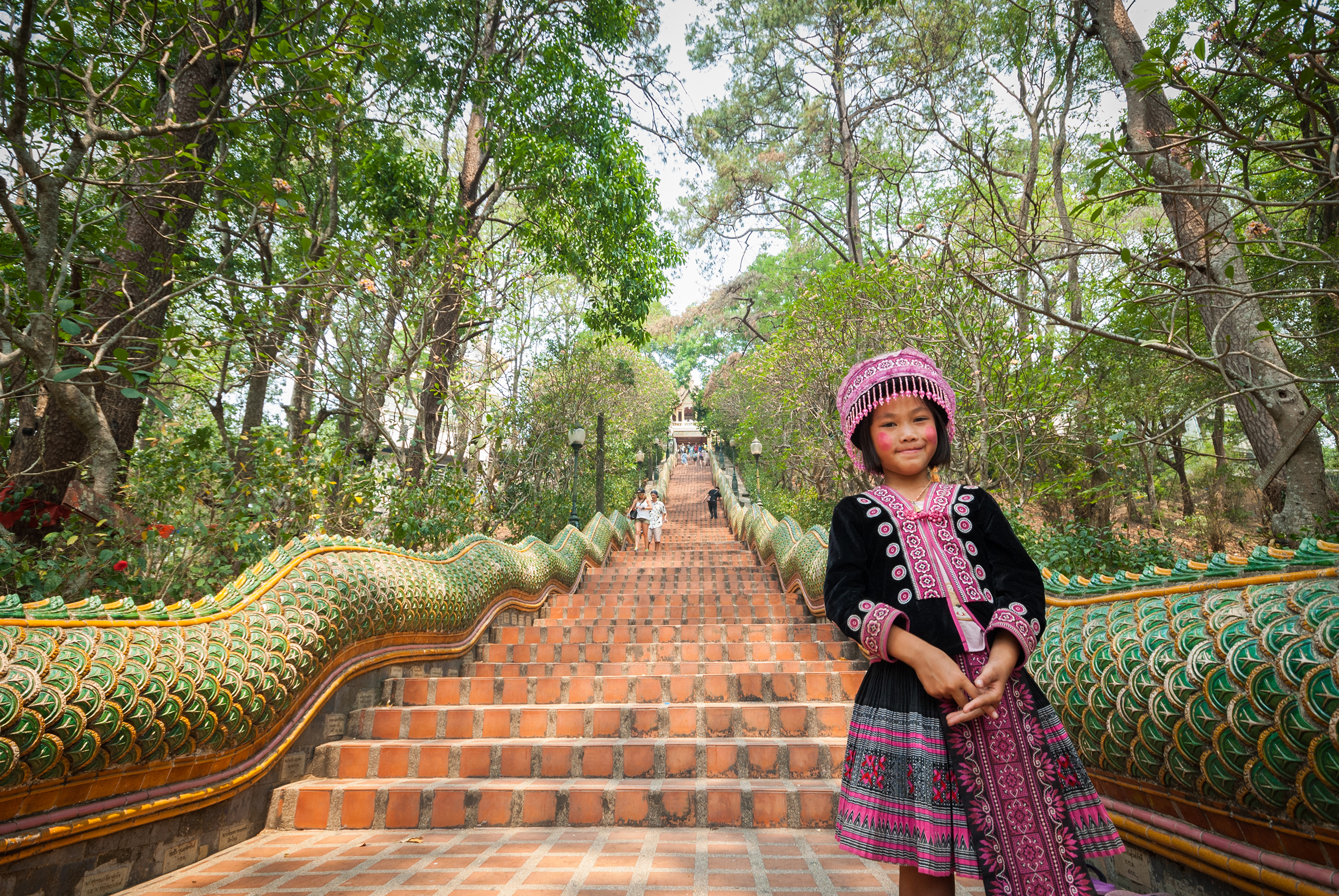Young girl stands on the bottom of the 309 steps in Wat Phra That Doi Suthep. One of the most important temples in Thailand. Chiang Mai, Thailand