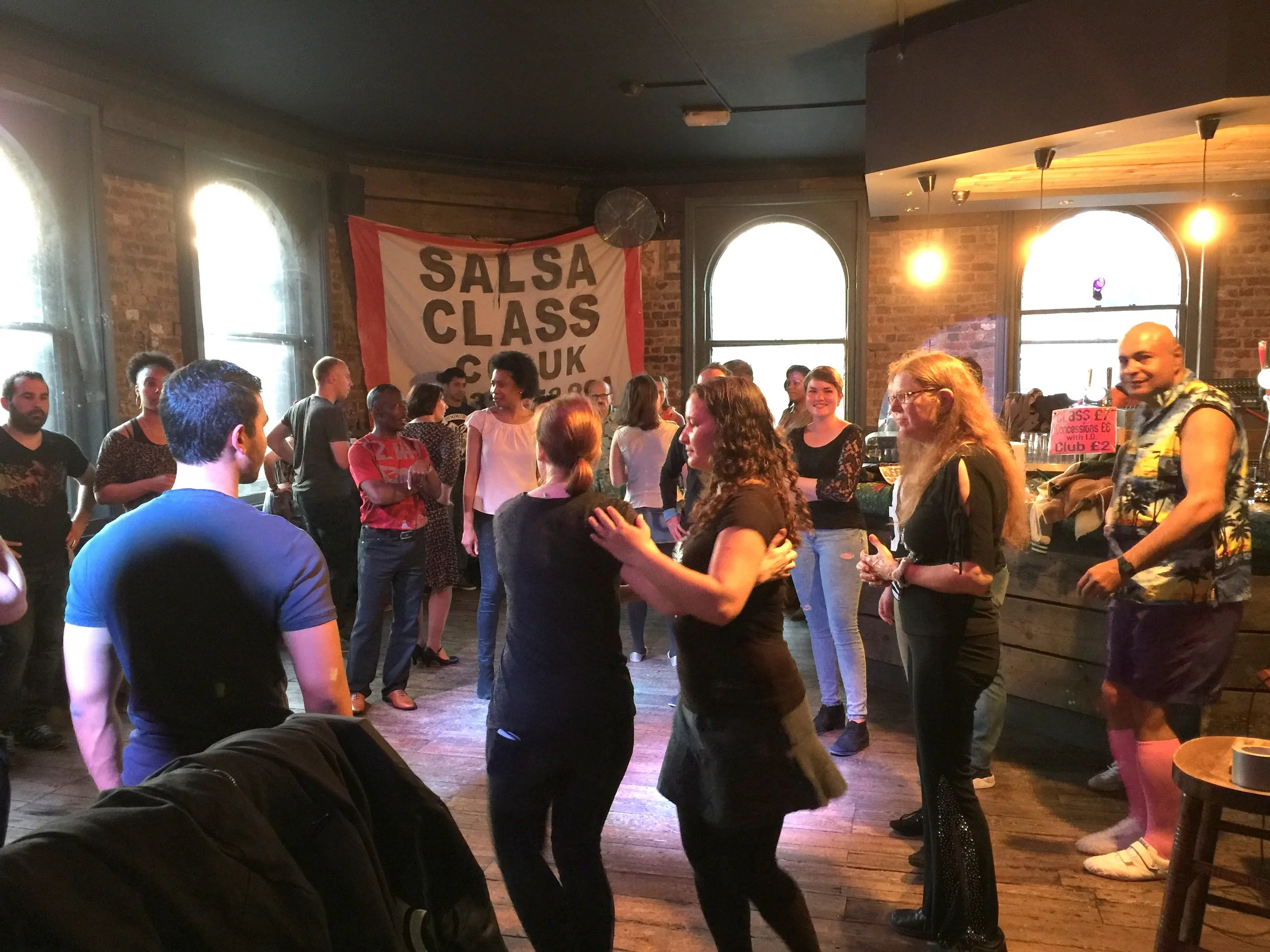 A salsa class being taught indoors