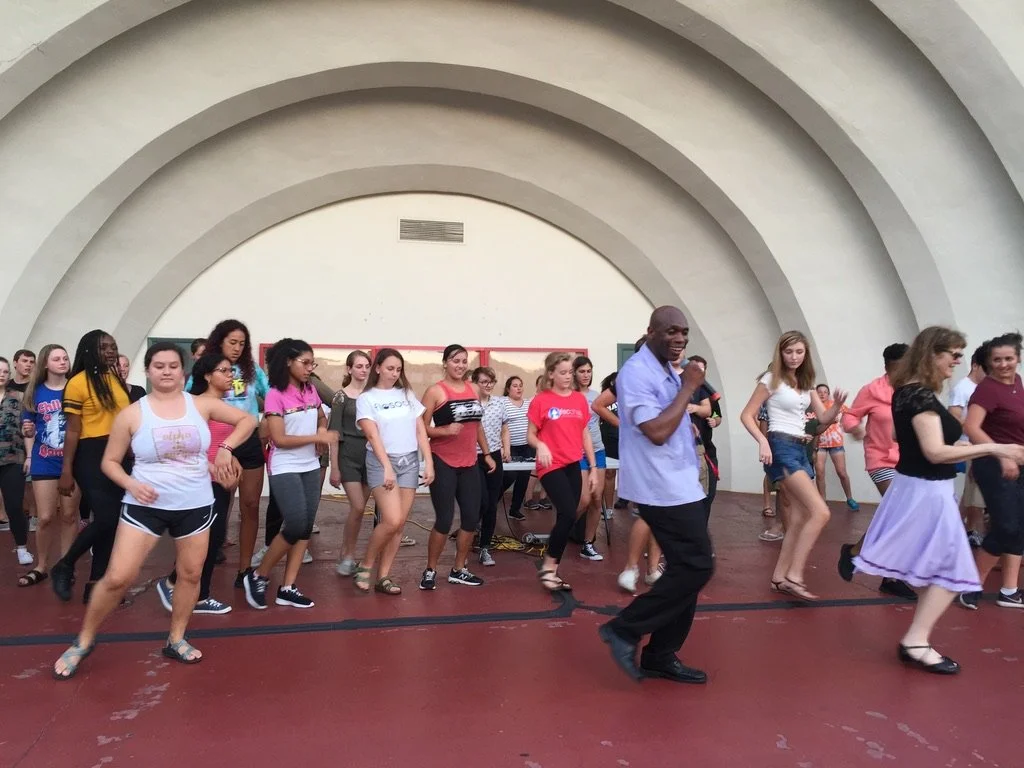 Glen teach Latin dances at a Hispanic Heritage Month program at a college in Florida.