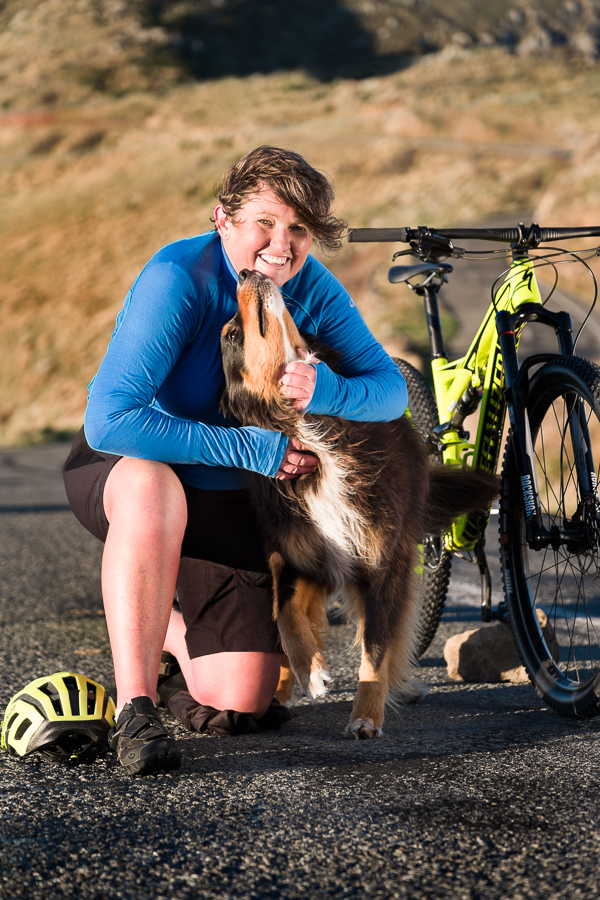 Leisa and Indy with their bike in the Christchurch Port Hills - vertical