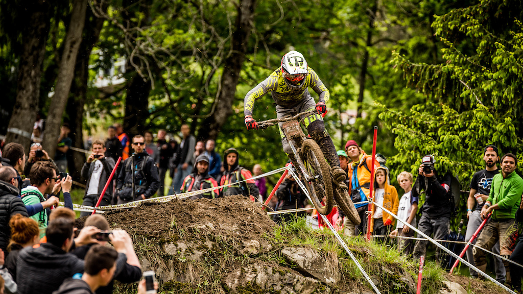 Coming into the finish for the win, Remi Thirion defeats the mud in the Crankworx Les Gets Downhill presented by iXS. Photo: Sean St. Denis/Crankworx