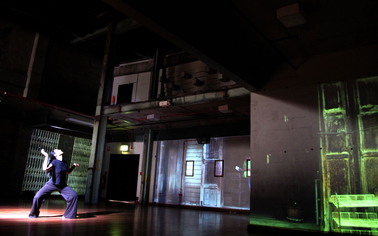 Scene from The Borrowed Language with Kobie’s video mapping projections