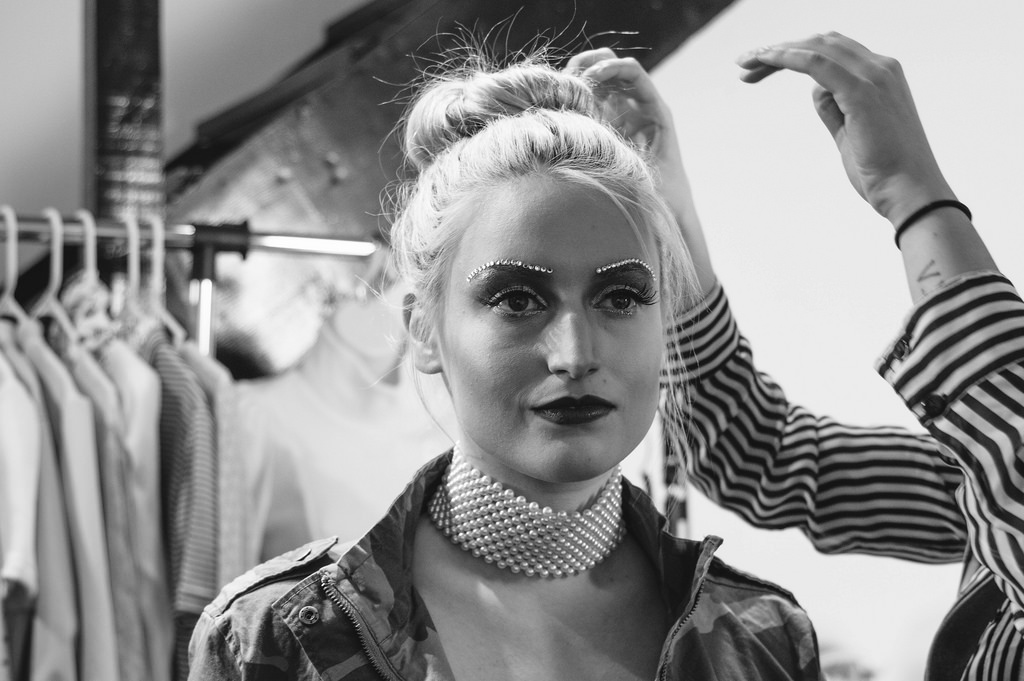 Model Melanie gets a touchup from Courtney. 