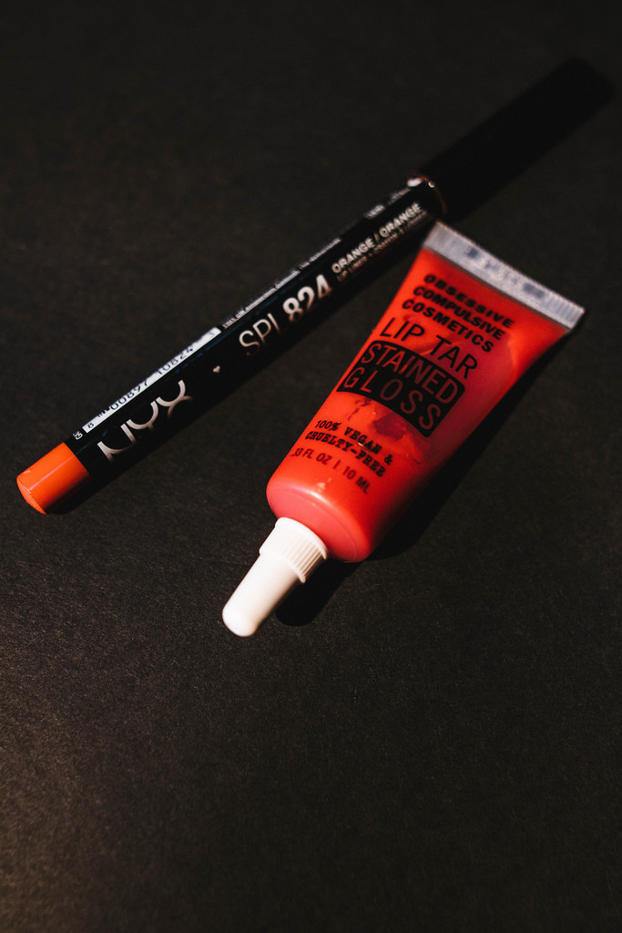 NYX Cosmetics Slim Lip Pencil in Hot Red. Obsessive Compulsive Cosmetics Lip Tar Stained Gloss in Meta. 