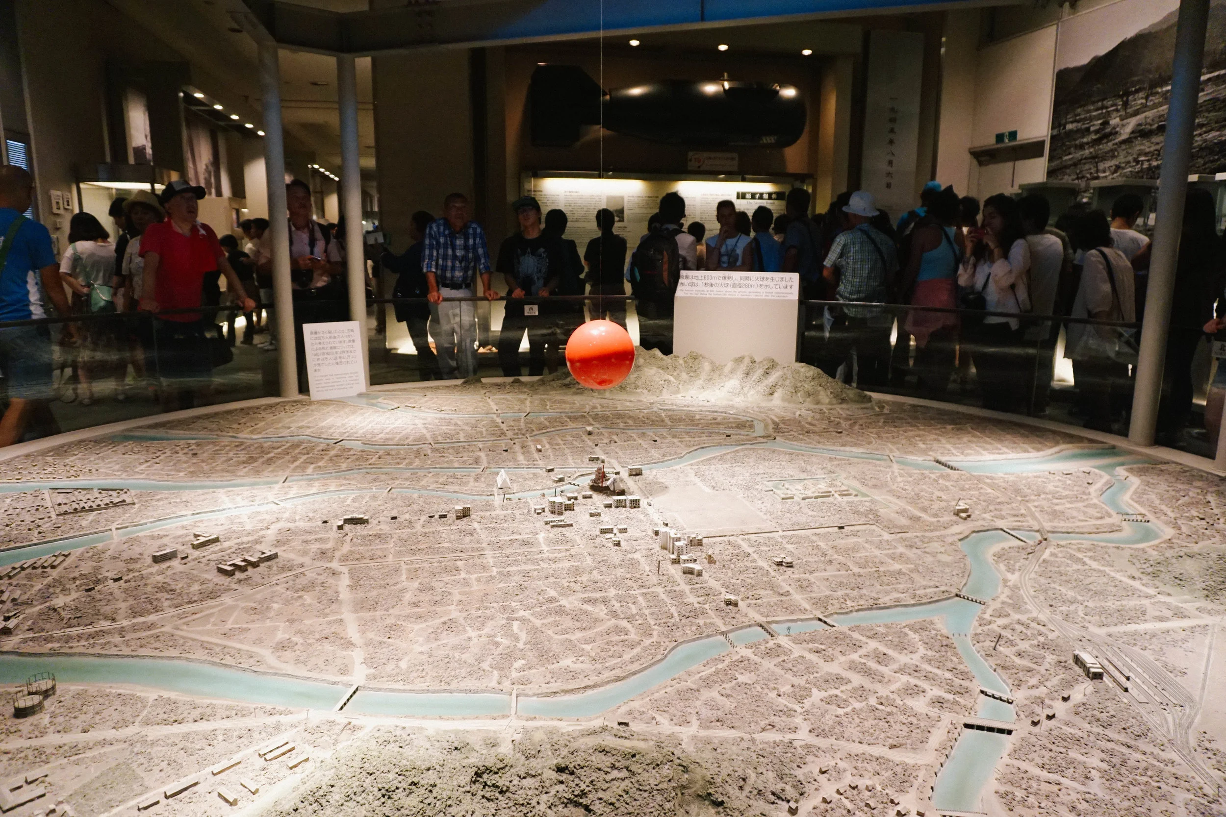 A rendering of the atomic bomb — depicted as the red ball — over Hiroshima.