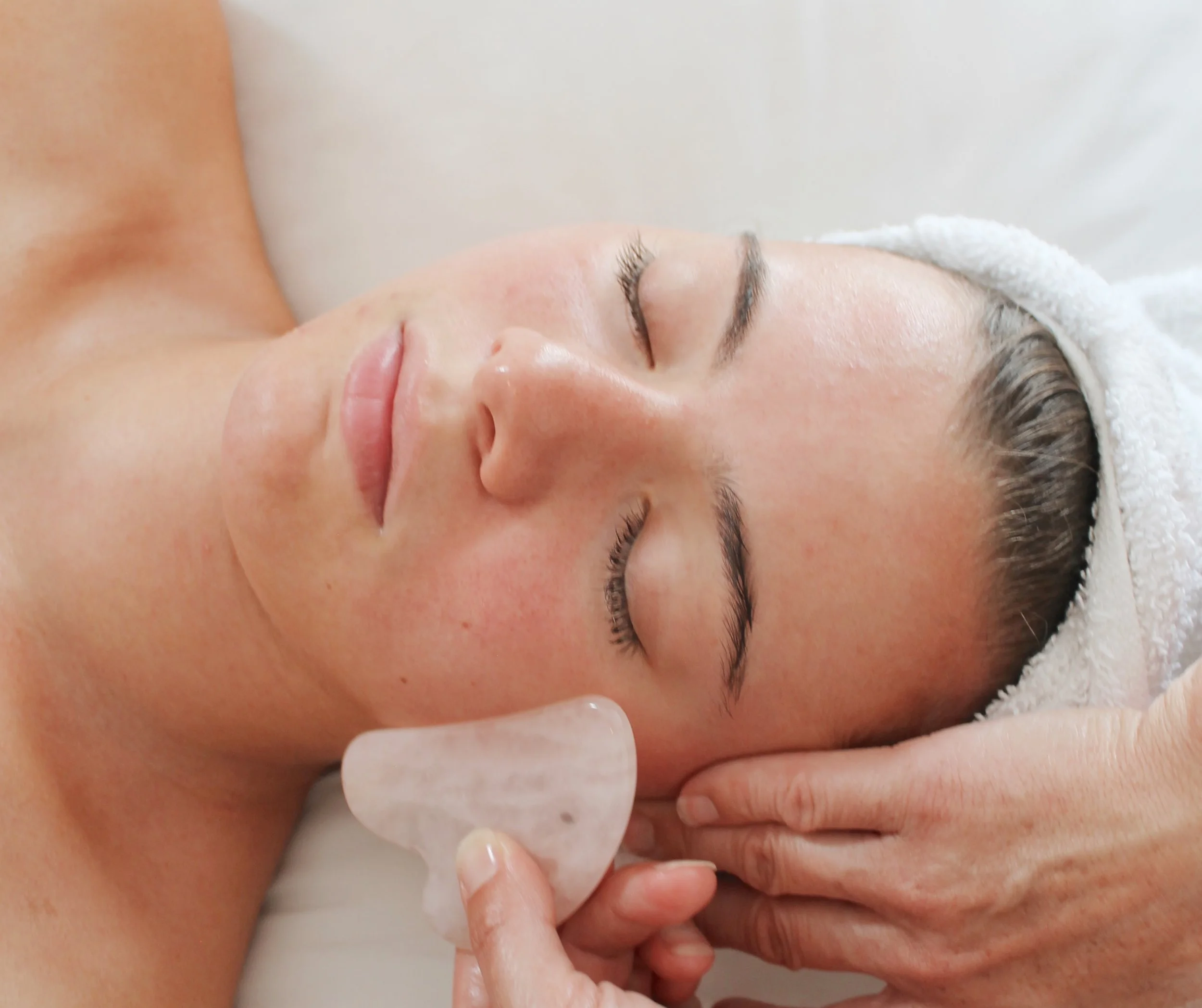 gua sha stone professionally used during facial massage