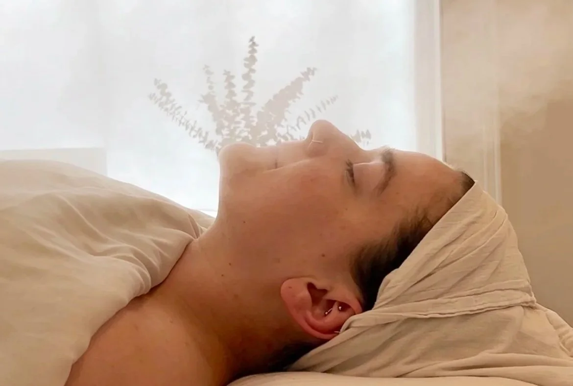 woman relaxing with eyes closed in spa with steam treatment
