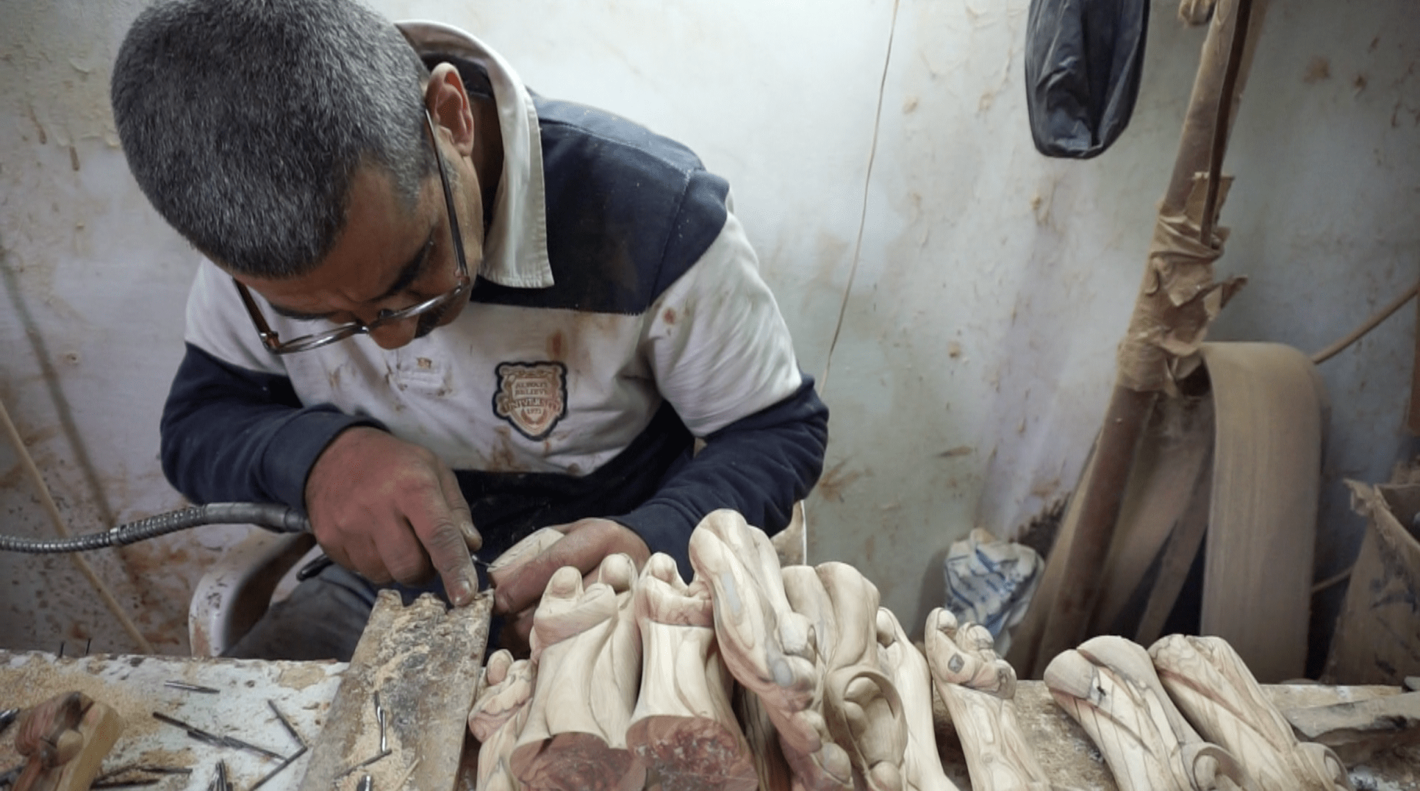 Hands carving olive wood in Beit Sahour